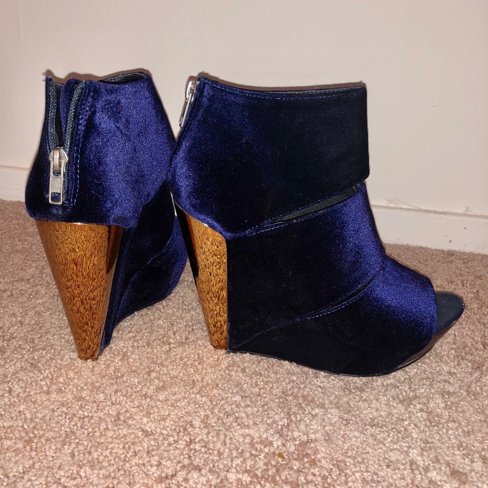 Chic velvet wedges in navy with gold heel accent.